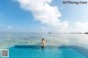 A woman sitting in the middle of a swimming pool.