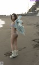 A woman in a bikini standing on a beach.