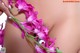 A close up of a person holding a bunch of flowers.